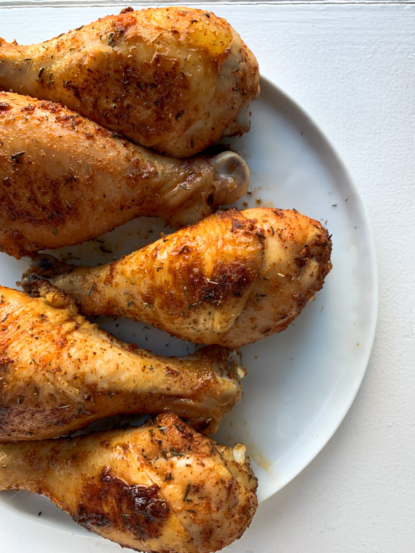 rotisserie chicken drumsticks on a white plate