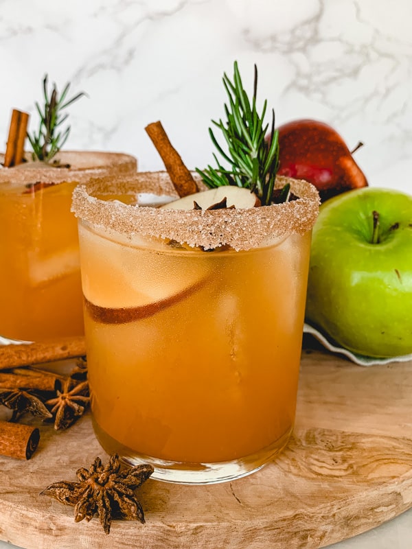 apple cider margarita with apples in background