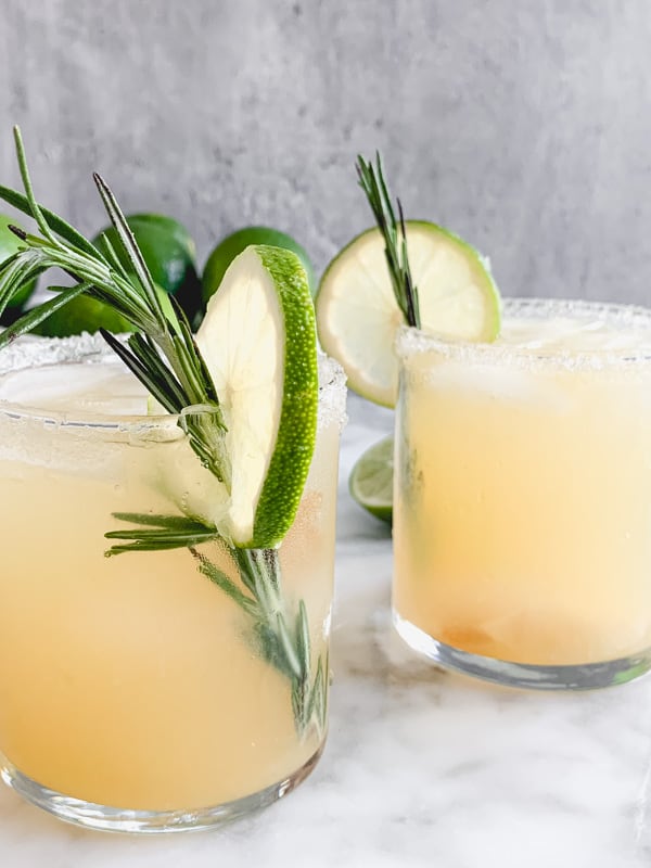 margarita with rosemary sprig and slice of lime